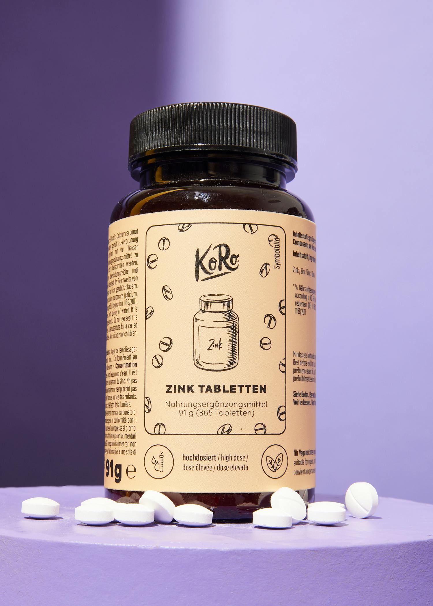 eine Flasche zinktabletten steht auf einem violetten Tisch