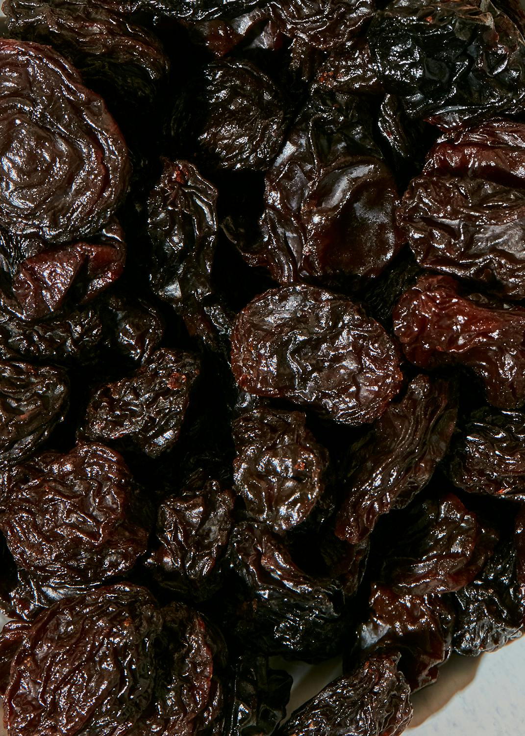 eine Nahaufnahme eines Haufens schwarzer Pflaumen
